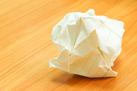 Paper ball - Crumpled Sheet of Writing Paper on Wooden Tableの写真素材
