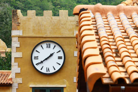 The round street watch outdoor on the wall of the buildingの写真素材