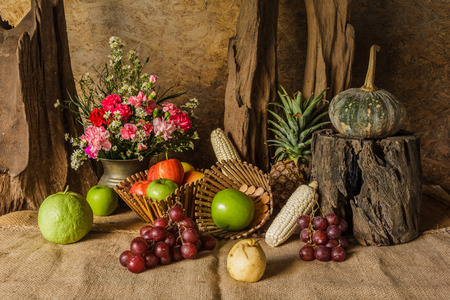 Still life with Fruits were placed together with a vase of flowers beautifully.の写真素材