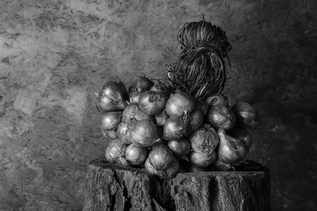 Still Life With Shallots, red onions on the timber.の写真素材