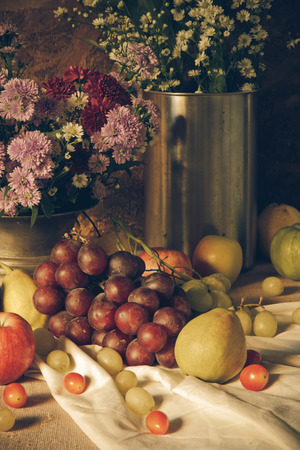 Still life with Fruits were placed together with a vase of flowers beautifully.の写真素材