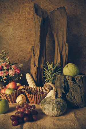 Still life with Fruits were placed together with a vase of flowers beautifully.の写真素材