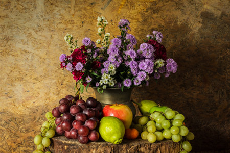 Still Life Fruits were placed on the timber with a beautiful vase of flowers.の写真素材