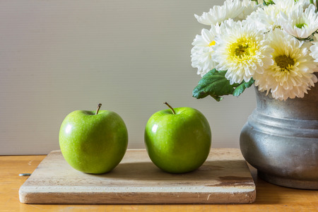still life with green apples on wooden tableの写真素材