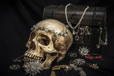 Still life with a human skull with old treasure chest and gold, diamond and jewelryの写真素材
