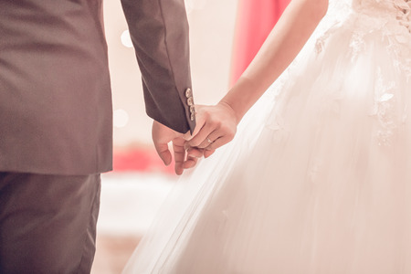 Hands of bride and groom with rings Interpretation of love. Wedding couple used as background illustrationの写真素材