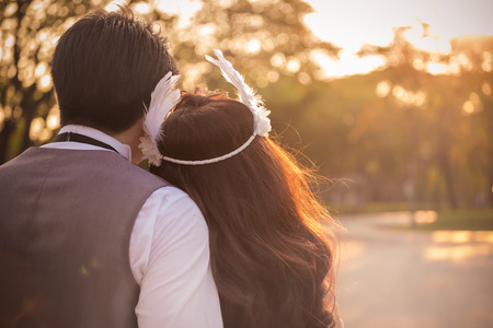 Pictures of the couple with the sunset as a symbol of love, illustrations and text.の写真素材