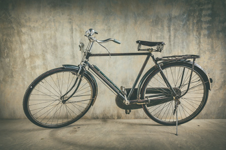 Old bicycle and background wall old vintage style.の写真素材
