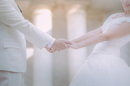 wedding theme, holding hands newlyweds a happy dayの写真素材