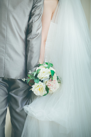 bride and groom holding hands a symbol of love and weddingsの写真素材