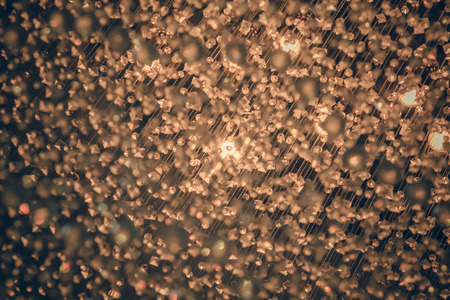 Bokeh golden yellow tones from light vintage celebrations as abstract background.の写真素材