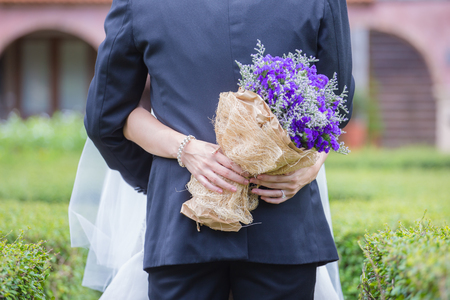 Newlyweds with a bouquet of beautiful flowers is the symbol of love and marriage.の写真素材