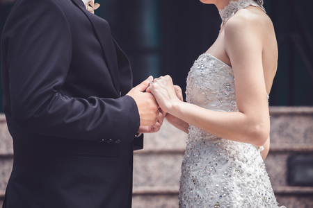 Wedding couple holding hands a symbol of love and marriage.の写真素材