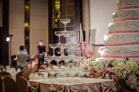 A glass of champagne at a party celebrating the wedding with beautiful bokeh background.の写真素材