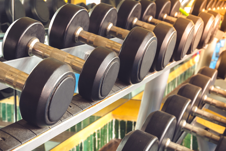The dumbbell for exercise is arranged neatly in the gym.の写真素材