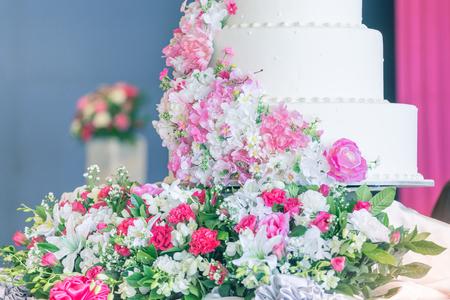 White wedding cake with flowers On a happy couple's dayの写真素材