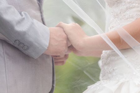 Bride and groom holding hands in wedding celemony a symbol of love