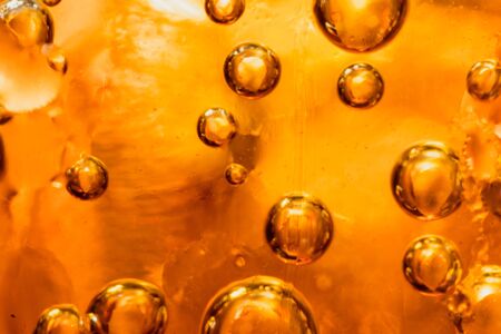 abstract water with  bubbles soars over a golden backgroundの写真素材