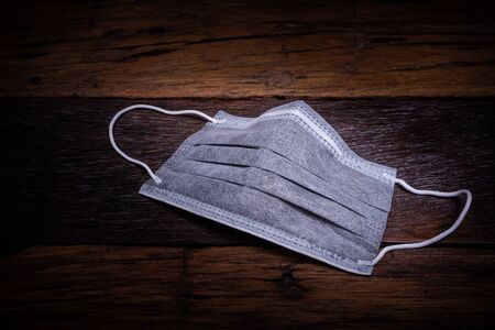 The surgical mask with covid 19 spread around the world. Impact of pandemic virus infection which represents a gloomy atmosphereの写真素材
