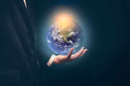 Businessman holding the earth with global connection concept. Energy saving conceptの写真素材