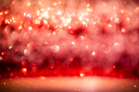 Red glitter vintage lights background defocused for festivals and celebrationsの写真素材