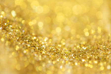 Gold light Festive Christmas background. Abstract twinkled bright background with bokeh defocused...