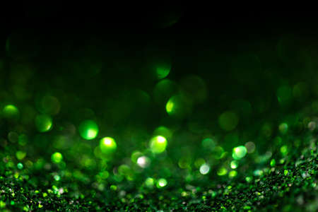 Green glitter vintage lights background defocused for festivals and celebrations
