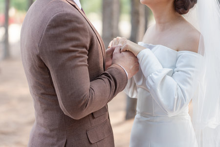 wedding theme background, holding hands newlyweds in celebration marriage dayの写真素材