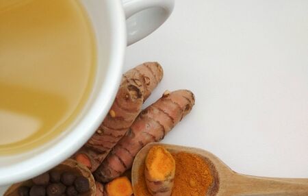 Ayurvedic drink, wooden spoon, root and powder turmericの写真素材