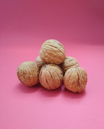 The Walnuts (Juglans regia) on pink background close upの写真素材