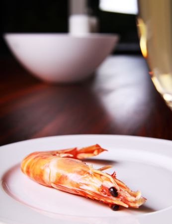 Giant shrimp on a plate and a glass of champagneの写真素材