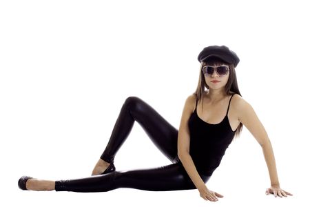 Latina fashion model in black clothes. Skin pants, a black beret and large sunglasses.の写真素材
