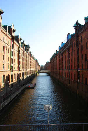 view at a canal between the famous Speicherstadt in Hamburg in Germanyの写真素材