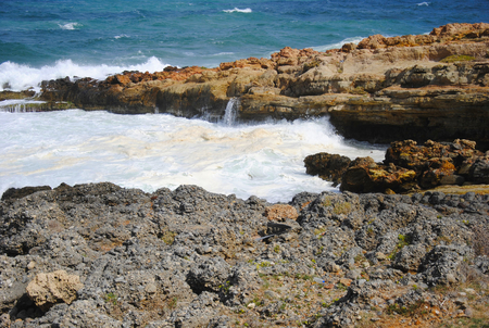 Breaking waves at the red rocky coast of Sissi on Crete in Greeceの写真素材