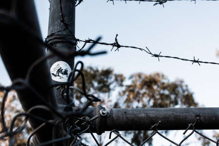 A photo of a sticker through a fence