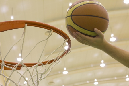 scoring basket in basketball courtの写真素材