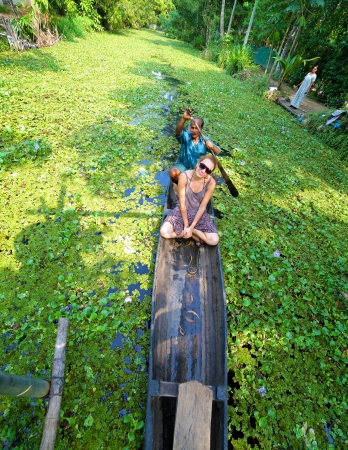 KERALA, INDIA - APRIL 2013: Canoe at alleppey backwaters with tourist girlのeditorial素材
