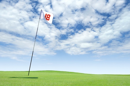 Golf flag at hole 18 on the putting greenの写真素材