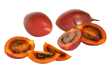 Red tamarillo fruit with cross sections showing ripe flesh and seedsの写真素材