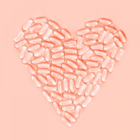 Healthy heart made from pills, on pink backgroundの写真素材