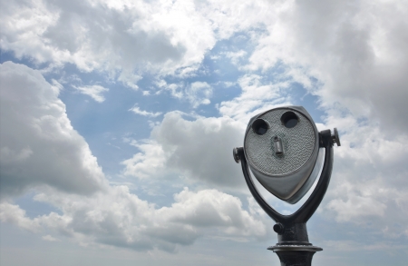 Coin-operated tourist binoculars aimed at a cloudy sky.の写真素材