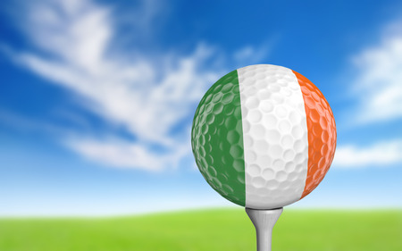 Golf ball with Ireland flag colors sitting on a teeの写真素材
