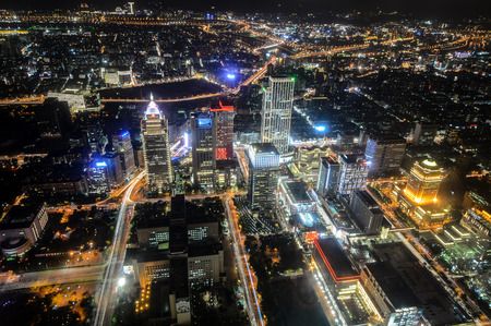 Aerial night view of Taipei, Taiwan with brightly lit streets and buildings glowing across the cityの写真素材