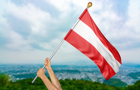 Young man's hands proudly waving the Austria national flag in the sky, part 3D renderingの写真素材