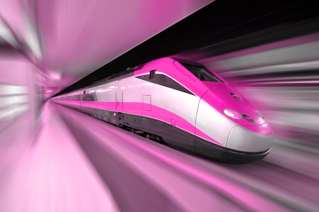 High speed bullet train traveling past a station in a fast blurの写真素材