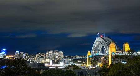 Sydney Harbour Bridge and surrounding cityscape illuminated at night in Australiaのeditorial素材
