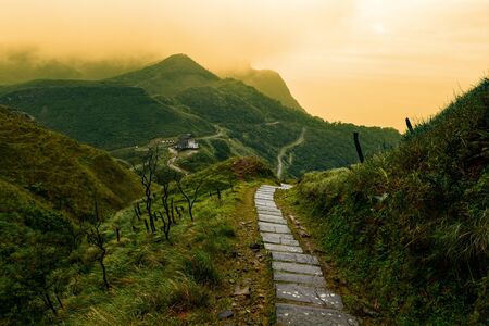 Storybook-like pathway through a misty mountain landscape in Taiwan's Yilan Countyの写真素材