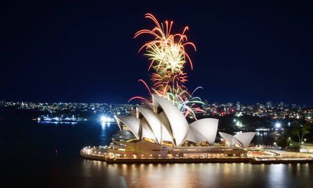 A colorful fireworks display erupts behind the Sydney Opera House after darkのeditorial素材
