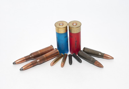 Bullets and shotgun shell isolated on white background