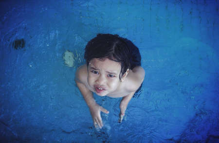 a boy at a poolの素材
